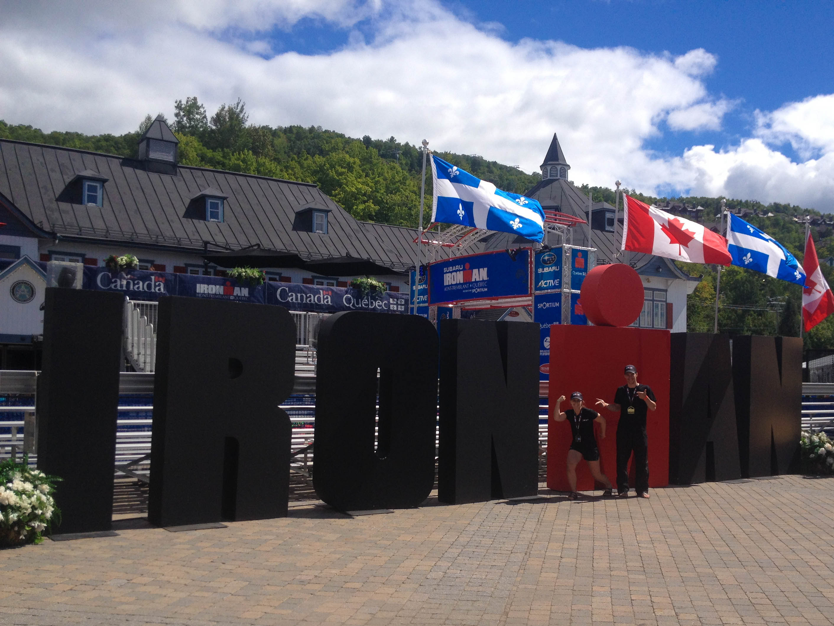 Ali's Gun Show In Front Of The Ironman Sign