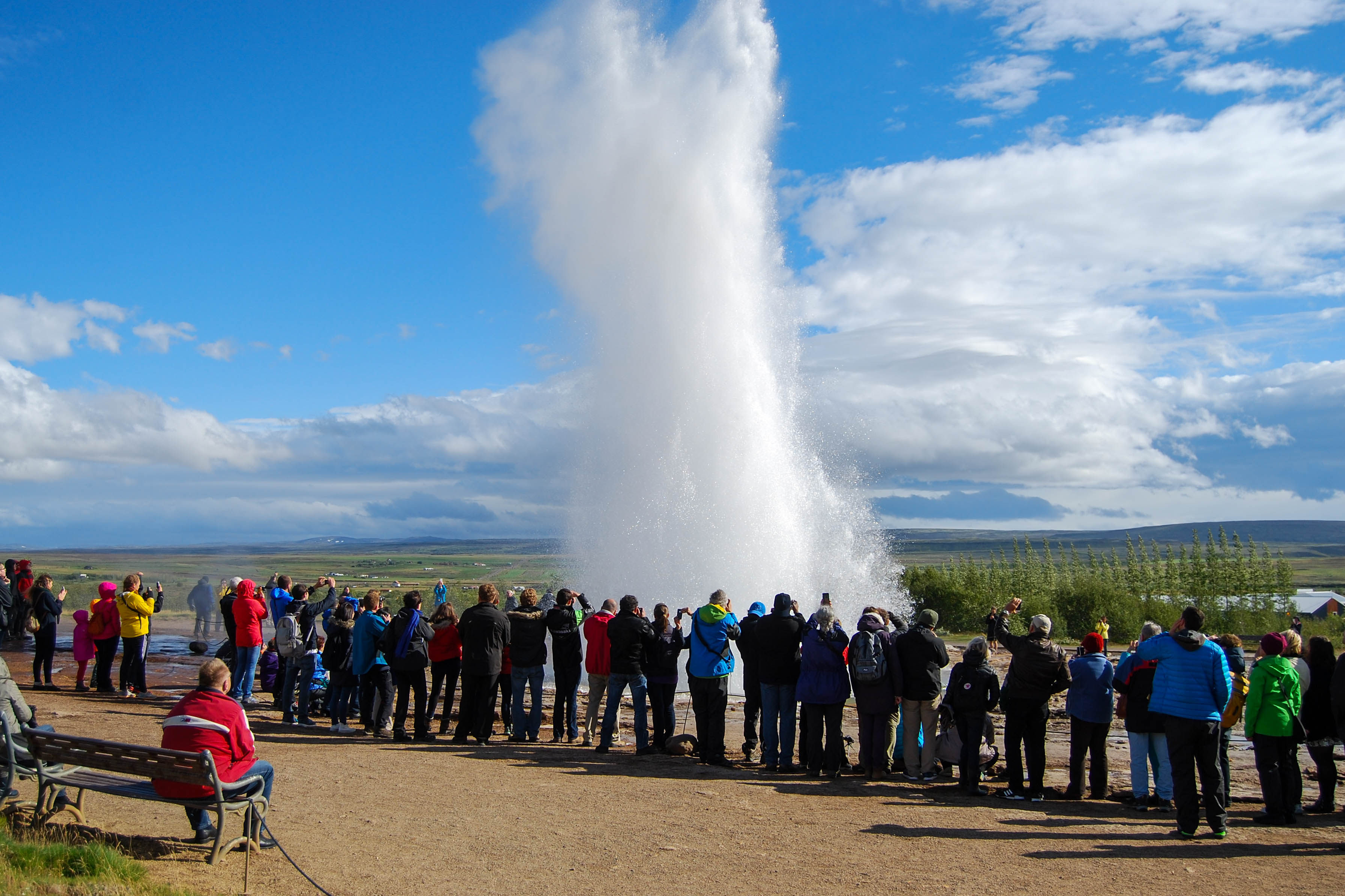 Group of People Around the Exploding Geysir in Iceland