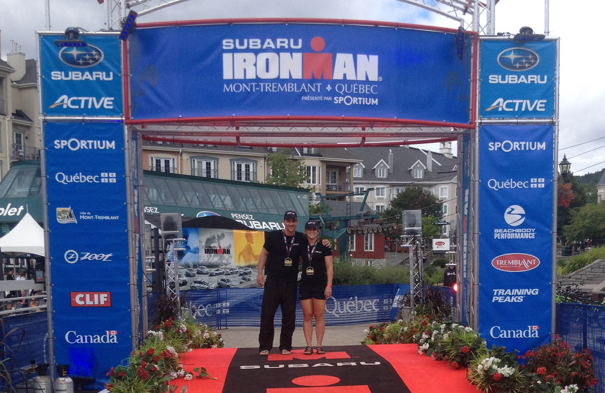 Joey And Ali Standing Together At The Ironman Finish Line