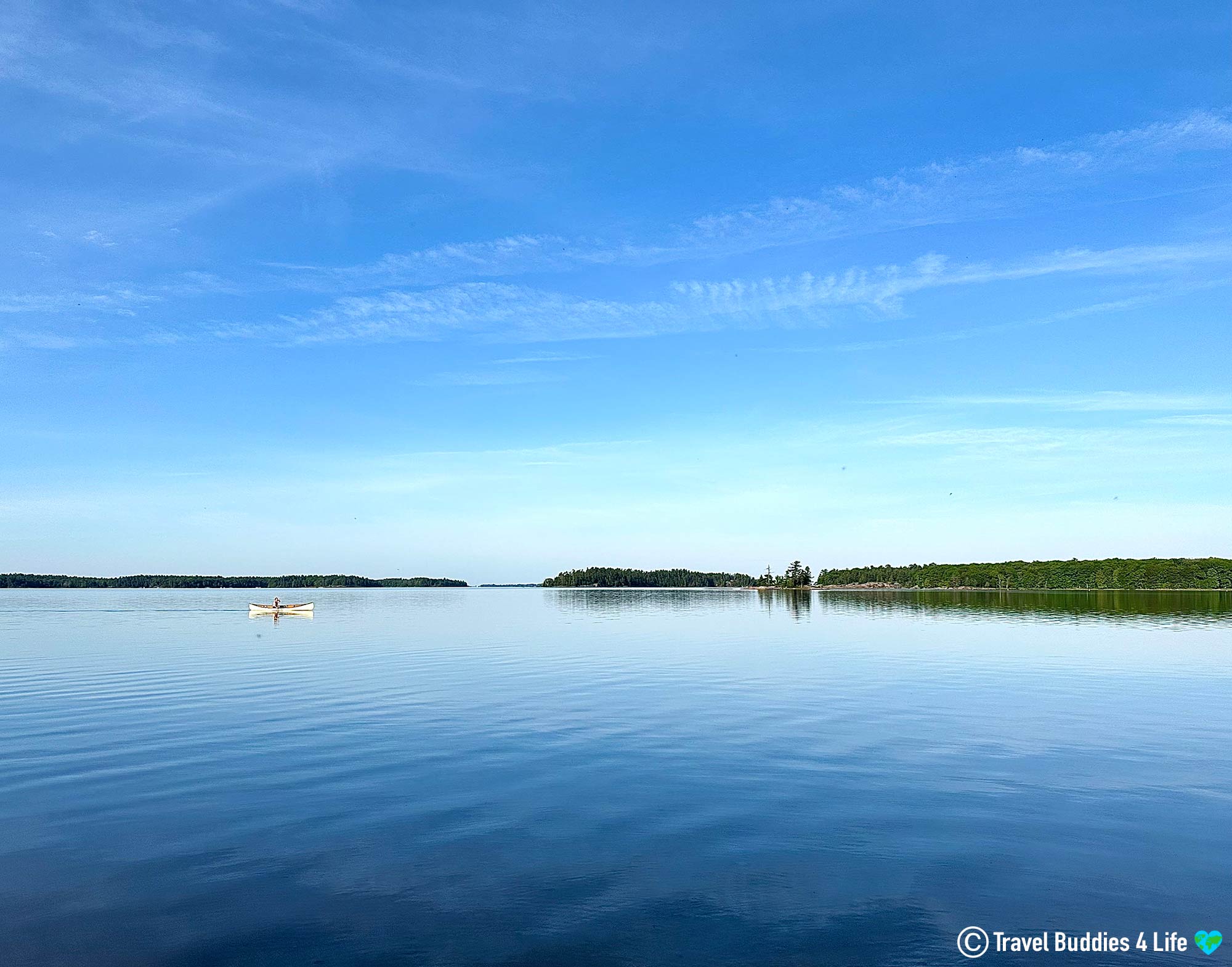 The Calm And Quiet Georgian Bay Of Lake Huron In The Early Hours Of The Morning With A Lone Canoe On The Water, Ontario Travel, Canada